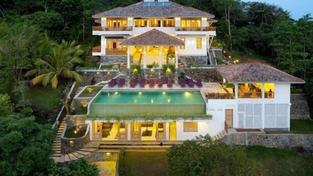 A multi-story house with a swimming pool, surrounded by lush greenery. - The Divine Villa (Heenatigala)
