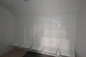 A restroom with white walls and a tiled floor. - K Avenue by Butter House @Sunset Seaview Cozy (Donggongon)
