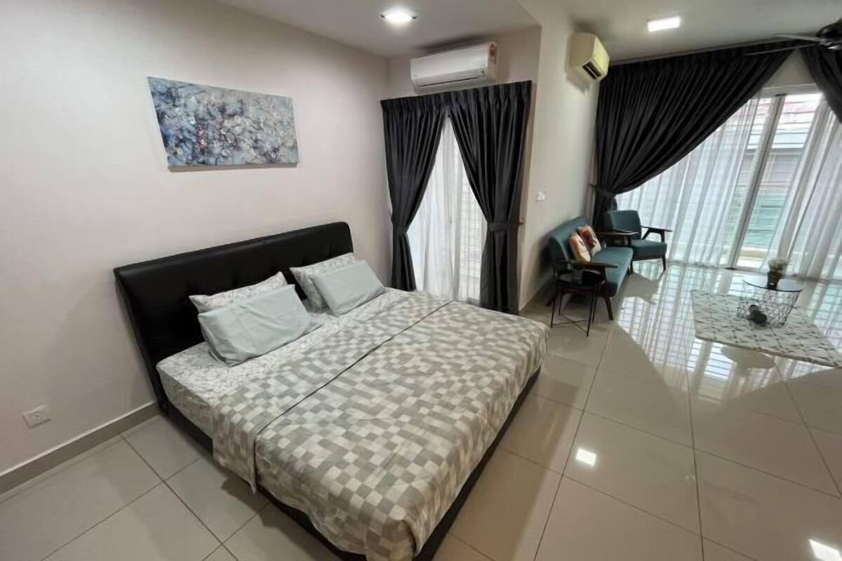 A bedroom with a bed, a desk, and a chair.
