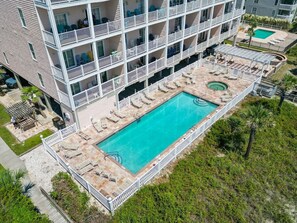 A multi-story hotel with a rooftop pool area, including sun loungers and a small circular pool. - Ultimate Getaway w/ pool & balcony access for 6BR (North Myrtle Beach)
