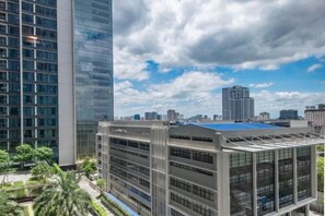 A modern building with multiple floors, large windows, and a parking structure. - Vinhome Metropolis Luxury Apartment - Tiramisu House (Hanoi)