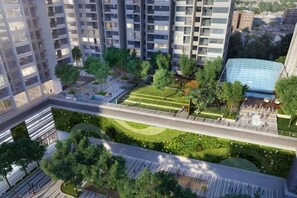A high-rise building with multiple floors, a rooftop garden, and a large glass structure. - Vinhome Metropolis Luxury Apartment - Tiramisu House (Hanoi)