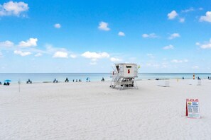 A lifeguard tower on a beach with clear skies. - Living Waters at Summer Salt (Orange Beach)