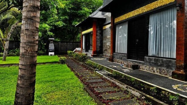 A modern building with a stone pathway leading to a set of steps.