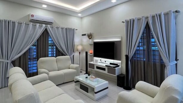 A modern living room with a sofa, coffee table, TV, and curtains. - Entire Vacation House In Sitiawan (Sitiawan)