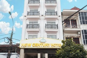 A hotel with a prominent sign reading 'NEW CENTURY HOTEL' and a balcony with decorative railings. - NEW CENTURY HOTEL LANG SON (Lang Son)