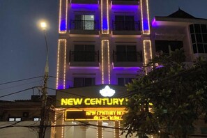 A hotel with illuminated signage, multiple floors, and a balcony. - NEW CENTURY HOTEL LANG SON (Lang Son)