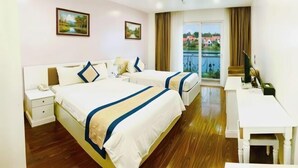 A hotel room with two beds, a desk, and a balcony with a view. - NEW CENTURY HOTEL LANG SON (Lang Son)