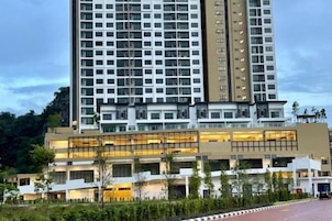A multi-story hotel with a modern architectural design, featuring a prominent entrance with glass doors and a flat roof.