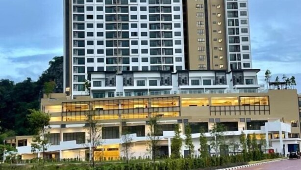 A multi-story hotel with a modern design, featuring a mix of glass and concrete facades, and a landscaped courtyard. - H&W Sunway Onsen Suite S-07-05 near Lost World of Tambun Ipoh (Ulu Kinta)