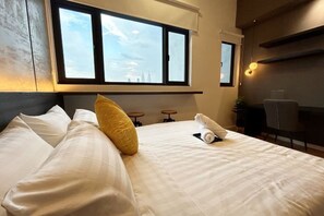 A hotel room with a bed, two windows, a desk, and a chair. - Chambers Residence by Manhattan Group (Kuala Lumpur)