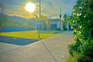 A paved pathway leading to a building with a clear sky and sunlight. - The Memories Hill Phuket (Phuket)