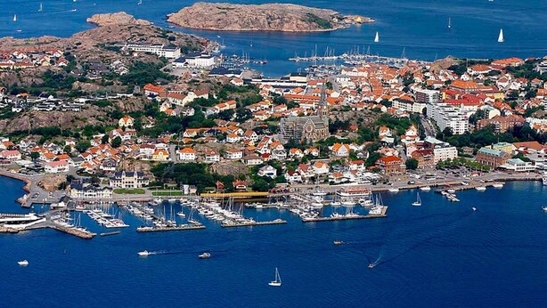 A coastal town with a marina, houses with red roofs, and a prominent church. - 6 Person Holiday Home in Lysekil (Lysekil)
