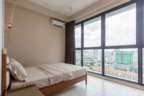 A bedroom with a bed, large windows, and an air conditioning unit. - Designer Suites George Town + LG Water Purifier【City View】 (Jelutong)