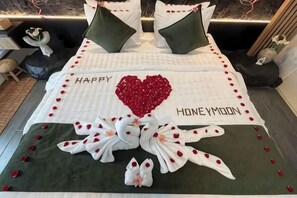 A bed with a heart-shaped decoration, pillows, and a message that reads 'HAPPY HONEYMOON.' - Landmark Villas (Bali)
