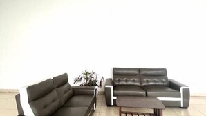 A modern living room with a sectional sofa and a coffee table. - IOI City, Serdang,UPM, Balakong,The Mines,Greenpark 3A (Kajang)