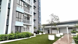 A modern building with multiple floors, balconies, and a well-maintained lawn area with potted plants. - IOI City, Serdang,UPM, Balakong,The Mines,Greenpark 3A (Kajang)