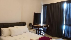 A hotel room with a bed, a desk, a chair, and a large window with curtains. - IOI City, Serdang,UPM, Balakong,The Mines,Greenpark 3A (Kajang)