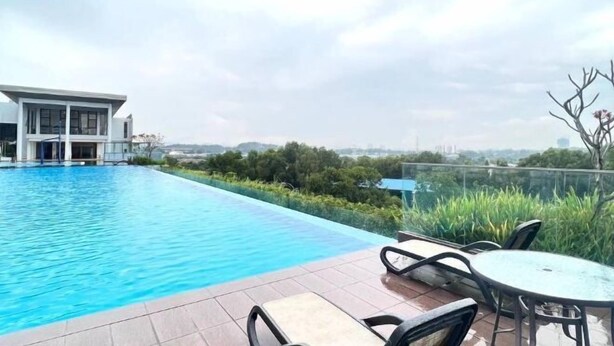 A swimming pool with a view of a modern building and greenery. - IOI City, Serdang,UPM, Balakong,The Mines,Greenpark 3A (Kajang)