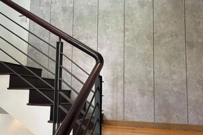 A staircase with a metal handrail and wooden steps. - Kim’s House Entire Villa 6-BR Near My Khe Beach (Da Nang)