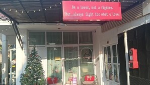 A storefront with a Christmas tree and wicker chairs outside. - Your House kkn. (Khon Kaen)