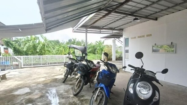 A covered parking area with several motorcycles parked. - Your House kkn. (Khon Kaen)