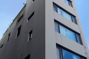 A modern building with multiple windows and a flat facade.