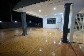 A covered outdoor area with tiled flooring, a column, and a door. - 3BR/12pax LYL Ipoh town- homestay-5min to town (Ipoh)