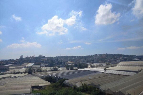 A large greenhouse complex with multiple sections, surrounded by a residential area. - KP Villa Dalat (Dalat)