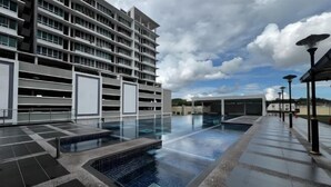 A modern hotel with a rooftop pool area, multiple floors, and a covered outdoor seating area. - Akademik Suite, Moccasin Suite by Antlerzone (Tebrau)