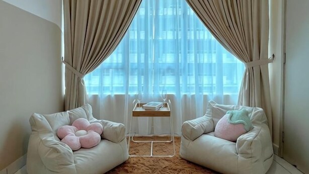 A room with two white sofas, a small table, and a view through sheer curtains. - Akademik Suite, Moccasin Suite by Antlerzone (Tebrau)