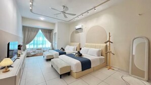 A hotel room with two beds, a ceiling fan, an air conditioning unit, a TV, and a large window with curtains. - Akademik Suite, Moccasin Suite by Antlerzone (Tebrau)