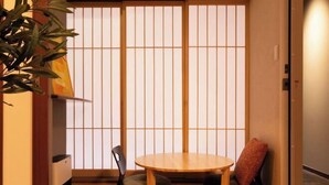 A traditional Japanese room with tatami flooring, a low table, and a shoji screen. - Lumie （Tamatsukuri） (Osaka)