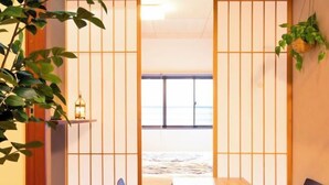 A traditional Japanese room with tatami flooring, a low table, and shoji screens. - Lumie （Tamatsukuri） (Osaka)