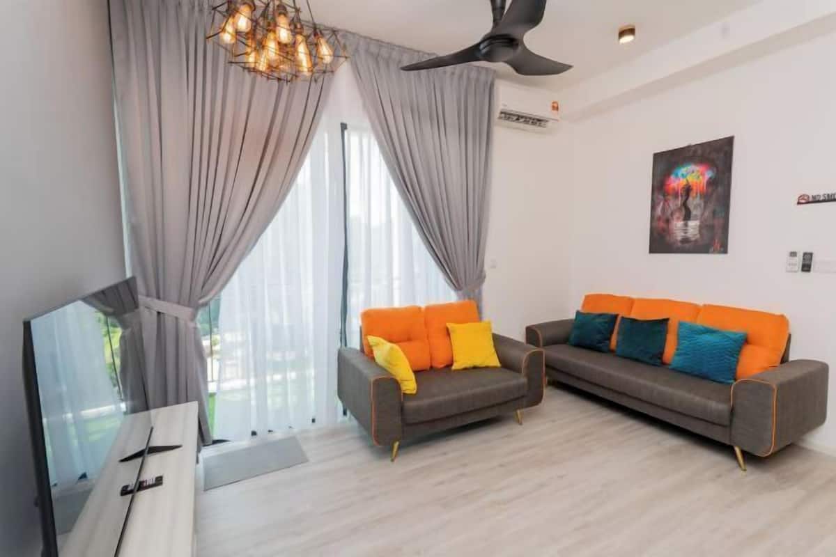 A modern living room with a sofa, TV, and curtains.