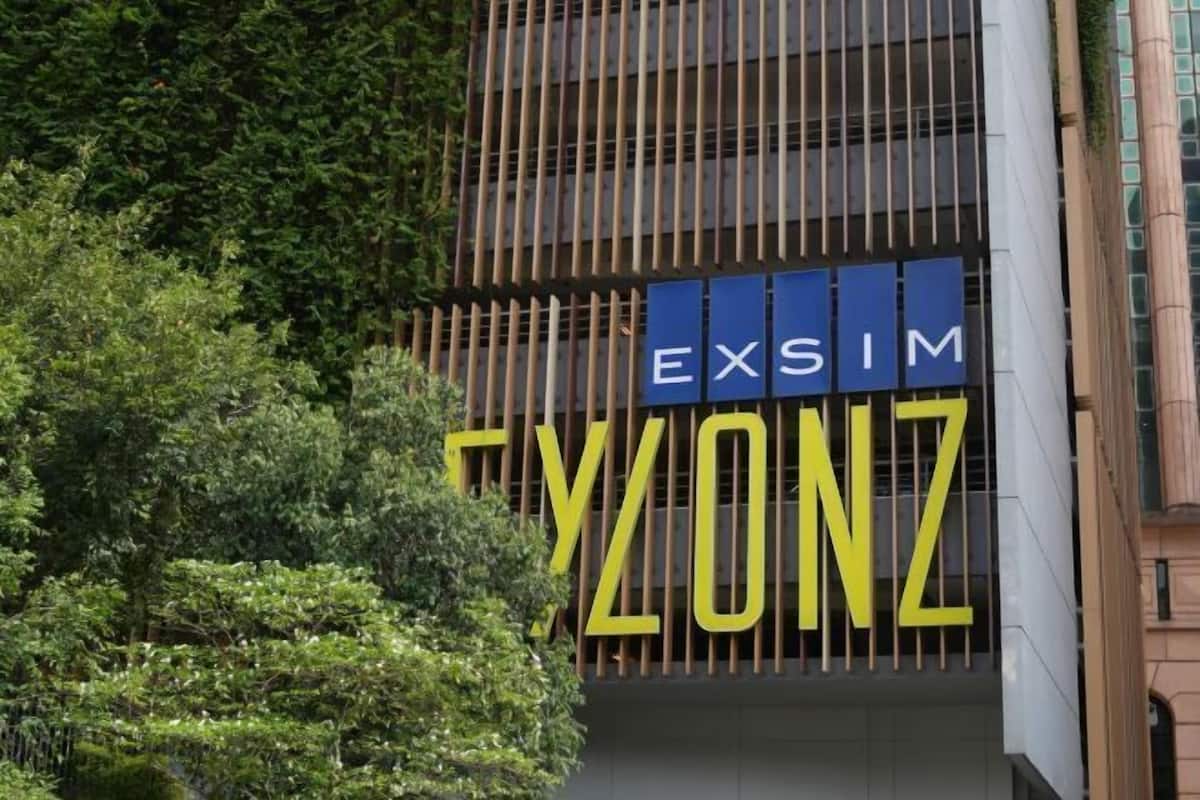A building with a sign that reads 'EXSIM TYONZ' in large letters.