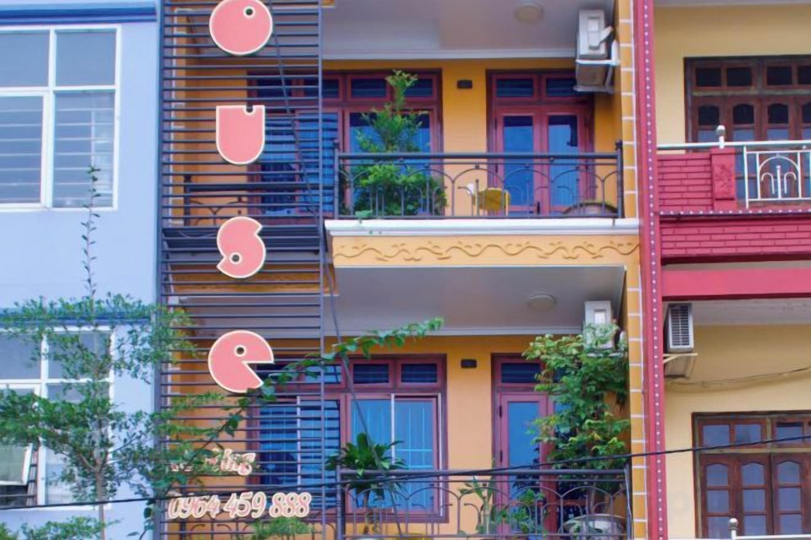 A multi-story building with balconies and windows.