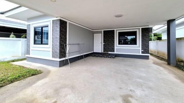 A modern house with a covered patio, a clothes drying rack, and a concrete floor. - We House - Hangdong 2 (Hang Dong)