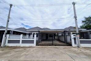A gated residential area with a covered entrance and multiple houses. - We House - Hangdong 2 (Hang Dong)