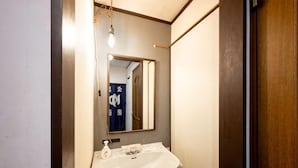 A bathroom with a sink, mirror, and hanging light fixture. - 8 min by train from Ikebukuro Station, 18 min from Shinjuku Station (Tokyo)