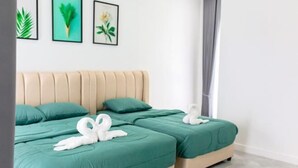 A hotel room with two beds, each with teal bedding and white swan-shaped pillows. There are framed botanical prints on the wall. - The White House Pool Villa Pattaya (Pattaya)