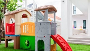 A children's play structure with multiple levels and slides, set on artificial grass. - The White House Pool Villa Pattaya (Pattaya)