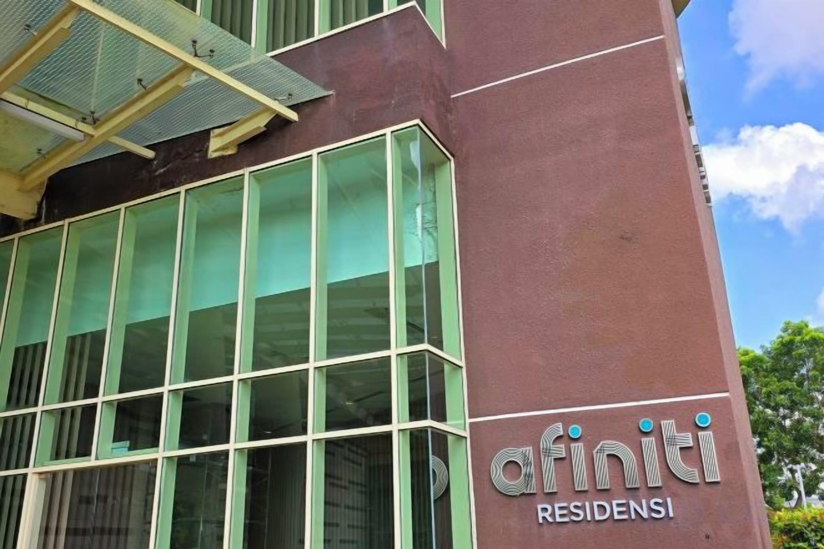 A building with a large glass facade and a sign reading 'afiniti residences'.