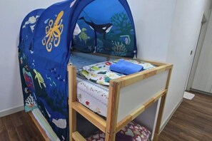 A child's bed with a tent-like canopy featuring marine life designs, a wooden frame, and a mattress with a patterned cover. - 2BR@Afiniti(8PAX) 3mins Walk to Legoland (Iskandar Puteri)