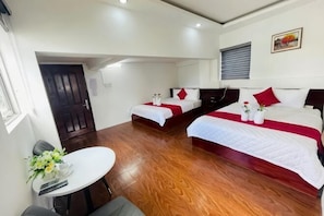 A hotel room with two beds, a dining table, and a small seating area. - Phu Gia Bui Vien Hotel (Ho Chi Minh City)