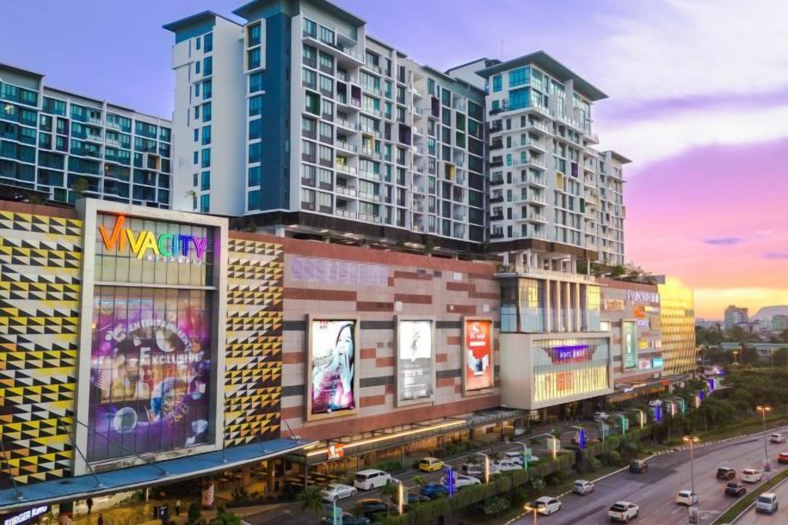 A multi-story hotel with a modern facade, large windows, and a prominent entrance.