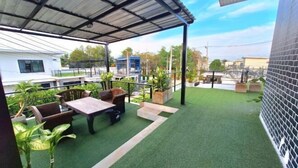 A covered outdoor area with artificial grass, seating, and potted plants. - Plus2 Hua-Hin Private Pool Villa from beach 3 km (Hua Hin)