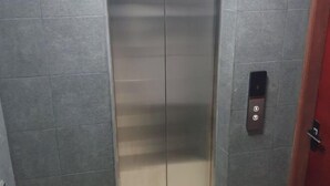 An elevator with a metallic interior and a control panel on the wall. - Fanfini Residence Male’ City (Malé)