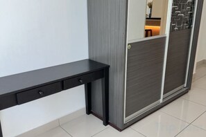 A room with a black console table, a sliding door with a patterned design, and a tiled floor. - HappySty in George Town Amazing sea view (George Town)
