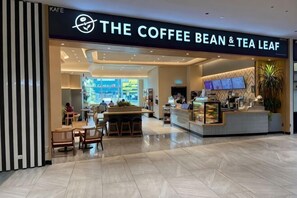 A coffee shop with a counter, seating area, and a menu display. - Elevated Cozy Homestay @Heart of Sri Petaling 3R3B (Kuala Lumpur)